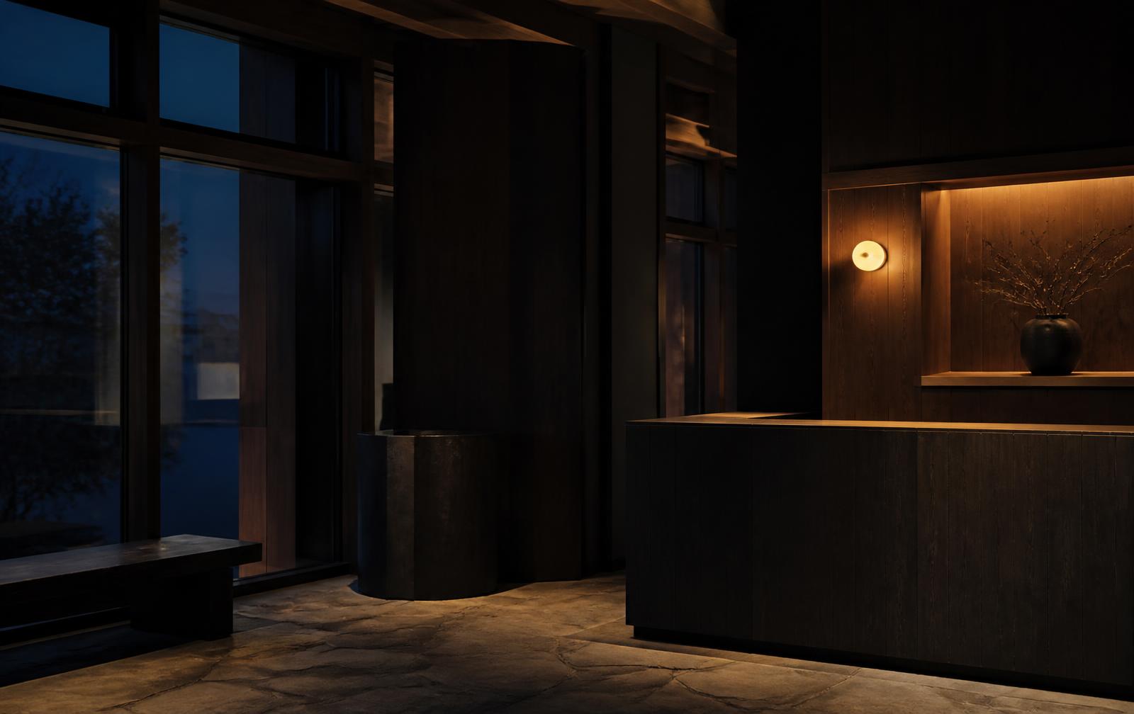 An interior at dusk, lit by a single warm source